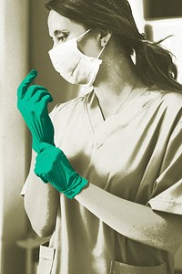 Doctor putting on a glove to prevent coronavirus contamination