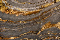 Gray marble rock with gold textured background