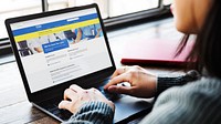 Woman reading coronavirus updates from a laptop mockup with editorial graphic from <a href="https://www.nhs.uk/" target="_blank">https://www.nhs.uk</a> accessed on April 8th 2020. BANGKOK, THAILAND - JANUARY 22, 2016