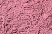 Crumpled rouge pink paper textured background