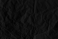 Crumpled black paper textured background