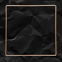 Square gold frame on a crumpled black background