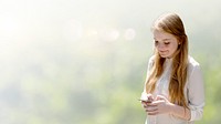 Pretty girl texting in a park