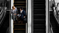Business people discussing on an escalator
