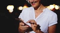 Closeup of woman texting at night
