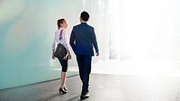 Asian business couple talking while walking