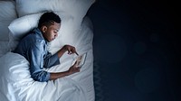 Man using a tablet in bed at night