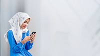 Muslim girl using a smartphone in the park