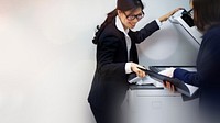 Asian woman using a photocopier