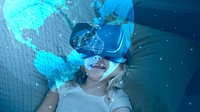 Little girl watching a movie through VR goggles