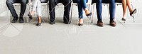 Group of diverse people sitting in a line on chairs