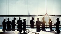 Silhouetted business people meeting in a boardroom