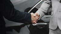Businessmen greeting by shaking hands
