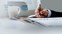 Businessman writing on his notebook