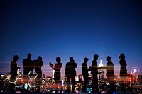 Group of silhouetted business people talking at night