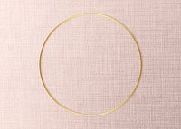 Round golden frame on a pink fabric background