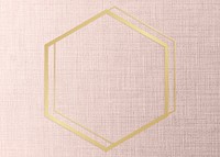 Gold hexagon frame on a peach fabric background
