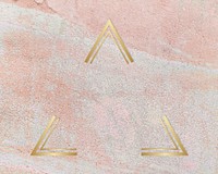 Gold triangle frame on a rustic pastel pink background