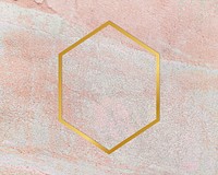 Gold hexagon frame on a rustic pastel pink background