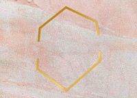 Gold hexagon frame on a rustic pastel pink background