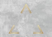 Gold triangle frame on a gray concrete textured background