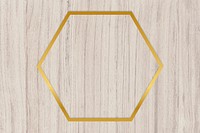 Gold hexagon frame on a wooden background