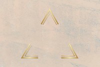 Gold triangle frame on a rough beige background