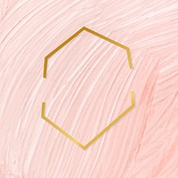 Gold hexagon frame on a pastel pink paintbrush stroke patterned background vector