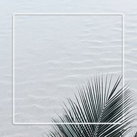 Palm leaf frame on a sand textured background 