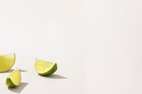 Slices of fresh green lime on white background