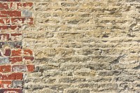 Grunge yellowish brick wall textured background vector