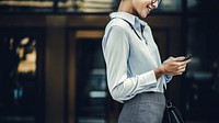 Businesswoman texting on her phone