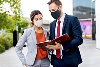 Business people in medical masks discussing work plan during coronavirus pandemic