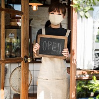 Japanese barista woman in face mask at cafe