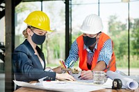 Architects in face mask planning construction in new normal