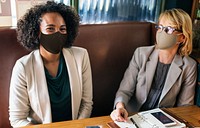 Women in face mask at cafe during lunch break