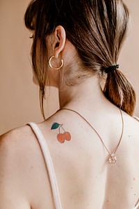 <br />Red cherry psd tattoo design mockup on a woman&rsquo;s shoulder 