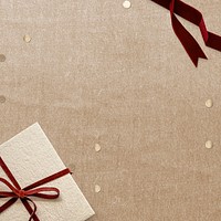 Christmas gift psd with confetti on beige background