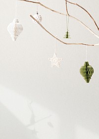 Christmas ornaments hanging on a tree on white background