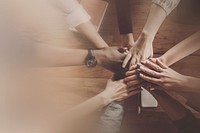 Diverse business teamwork stacking hands