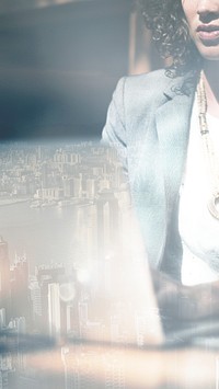 Businesswoman working on a laptop city background