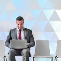 Businessman working on a laptop triangle pattern background