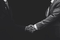 Business partners shaking hands monochrome