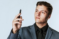 Young businessman holding smart pen