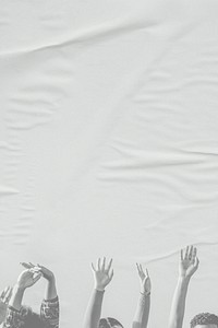 White arms raising on paper textured background