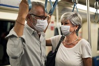 Couple wearing masks in train in the new normal