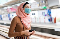 Muslim woman with mask on the train platform