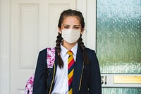 Girl wearing a mask and going to school in the new normal