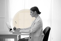 Female doctor working on a laptop in black and white