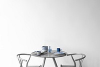 Wall mockup psd by the table with porcelain tableware on top